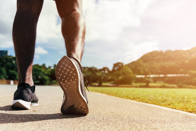 corridore sportivo uomo nero indossare piedi attivi pronti per correre all'aperto sulla strada della linea del tapis roulant