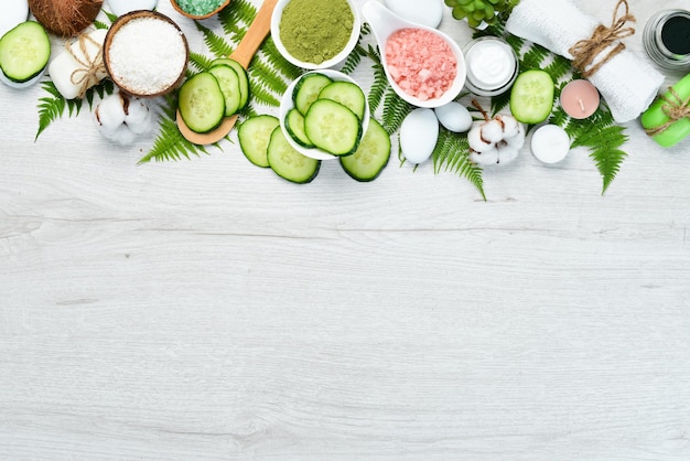 Cosmetici naturali di cetriolo verde su sfondo bianco di legno Il concetto di cosmetici e spa Vista dall'alto Spazio per la copia gratuito