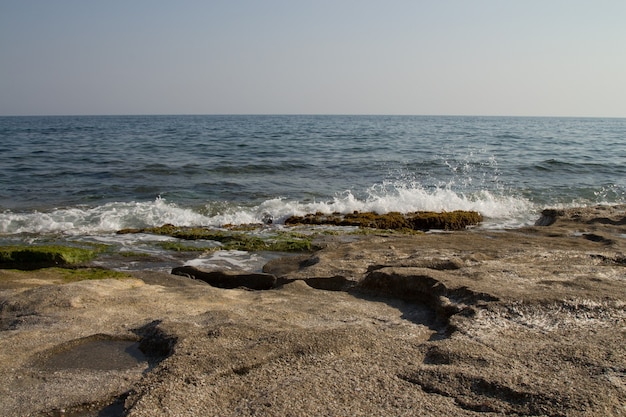 Costa rocciosa del Mar Mediterraneo. Vento, onde, spiaggia deserta. Una vacanza al Sud