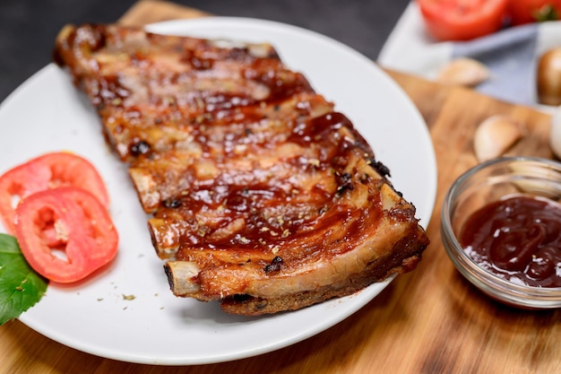 Costolette di maiale fatte in casa con marinata barbecue e salsa di immersione. Cucinare a casa durante le vacanze invernali.