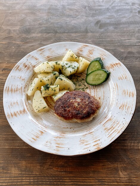 Cotoletta di pesce con patate e verdure. cotoletta di luccio con erbe e verdure