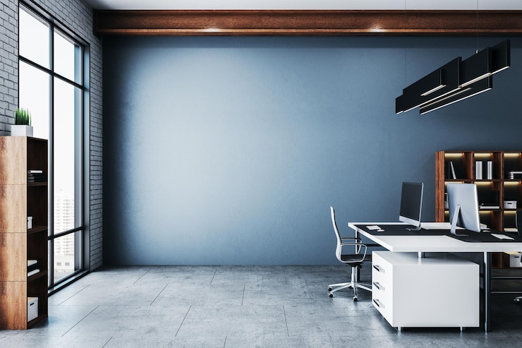 Photo coworking office in a loft style interior with blank blue wall
