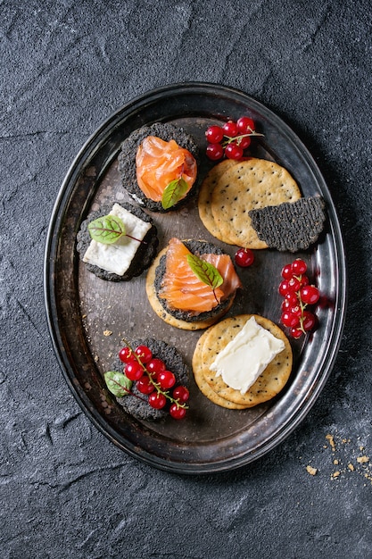 Cracker neri con salmone e frutti di bosco