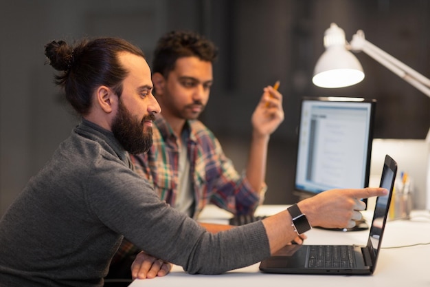 creative team with computer working late at office