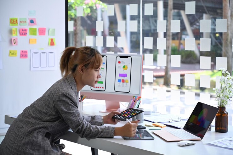 Photo creative woman is working on application development prototype wireframe for mobile phone