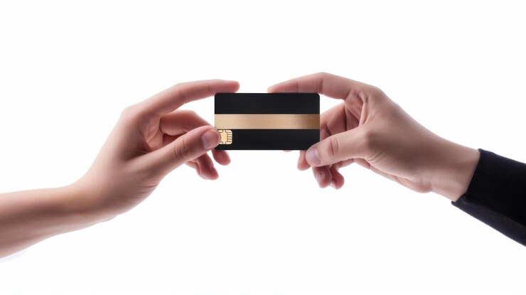 Credit card in the hands of a man and a woman on a white background