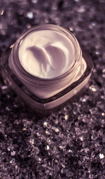 Crema viso di lusso per una pelle sana su sfondo glitterato lucido cosmetici idratanti spa e prodotti di bellezza naturali per la cura della pelle