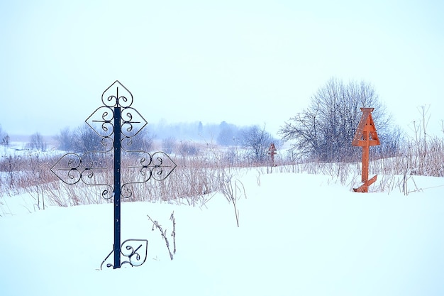 croce invernale del cimitero / concetto di solitudine dolore, croce nel paesaggio invernale