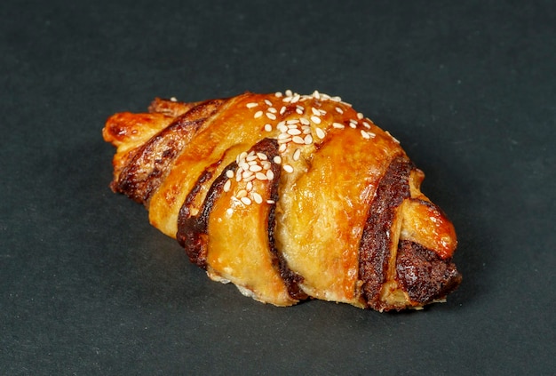 Croissant al cioccolato da vicino su sfondo nero