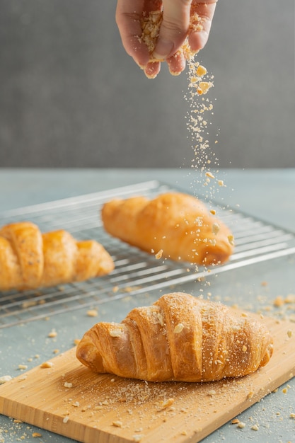 Croissant appena sfornati sul piatto di legno.