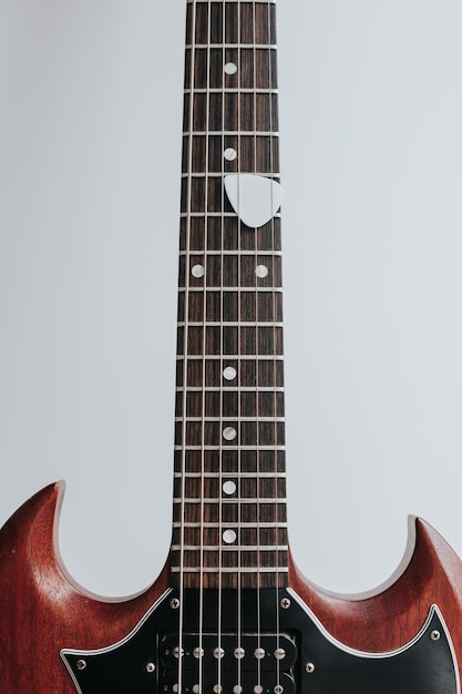 Crop shot o chitarra in legno su sfondo bianco