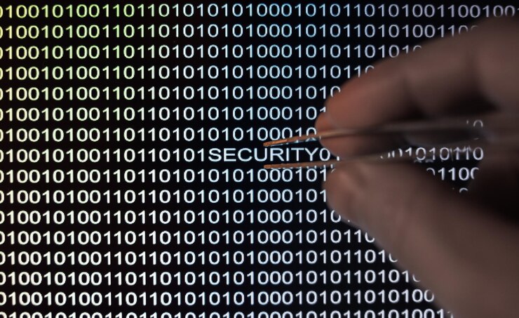 Photo cropped hand holding tweezers against binary codes