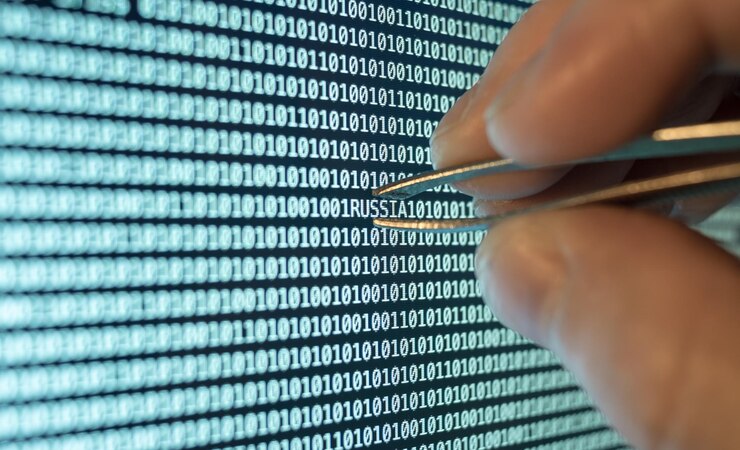 Photo cropped hand of person touching binary codes with tweezers