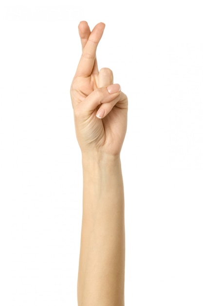 Crossed fingers. Woman hand gesturing isolated on white