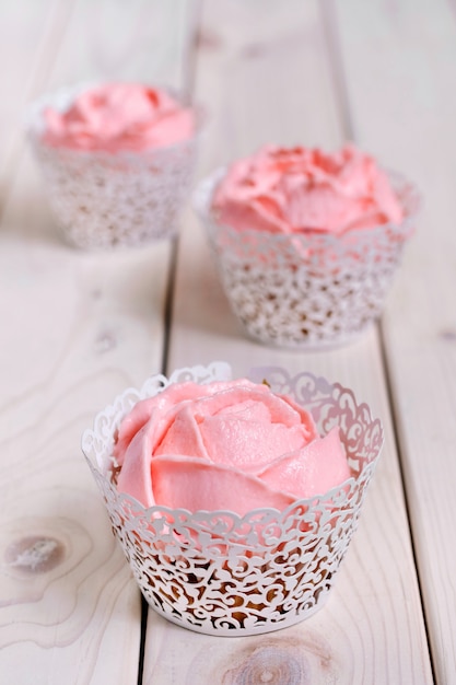 Cupcakes con crema rosa su sfondo bianco.