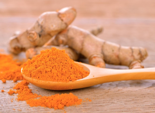 Curcuma in polvere in cucchiaio su legno Questa erba ad alto contenuto di vitamina C Vitamina c per proteggere il virus