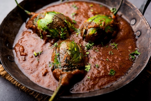 Curry di melanzane noto anche come baingan piccante o masala di melanzane, una popolare ricetta indiana servita in una ciotola, karahi o padella