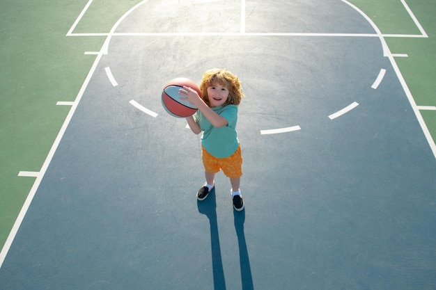 Cute little child boy training basket Scuola di basket per bambini