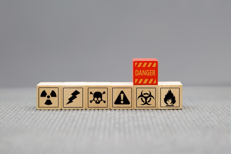 Photo danger icons on wooden cubes shape.