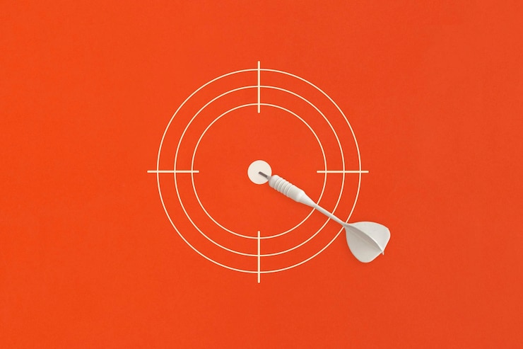 Photo dart on red target top view flat lay