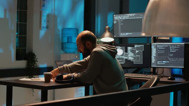 Database developer searching for something on desk, trying to work on app programming with html script. Young man looking for files, artificial intelligence cloud computing interface.