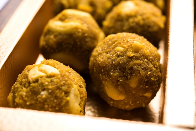 Date palline di farina d'avena o frutta secca Laddu in un piatto di confezione regalo, messa a fuoco selettiva