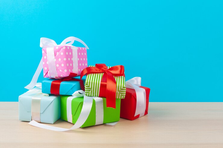 Photo decorated gift boxes on light blue background