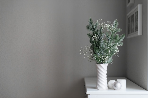decorazione minimalista di capodanno composizione di rami di abete e gipsofila in vaso