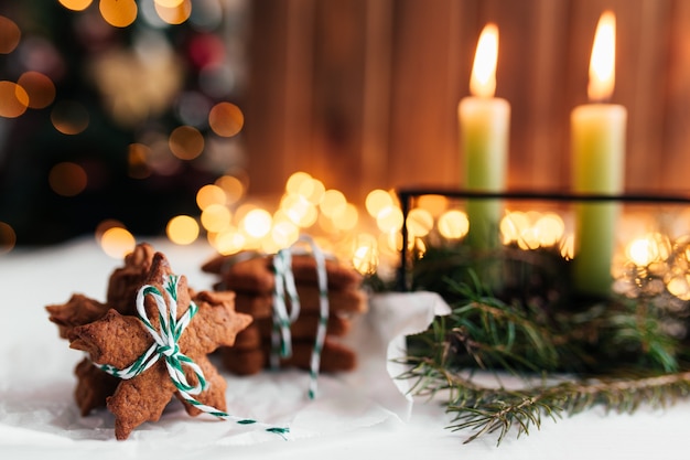 Decorazioni natalizie con candele, rami di abete e pan di zenzero