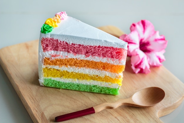 Deliziosa torta arcobaleno sul piatto di legno