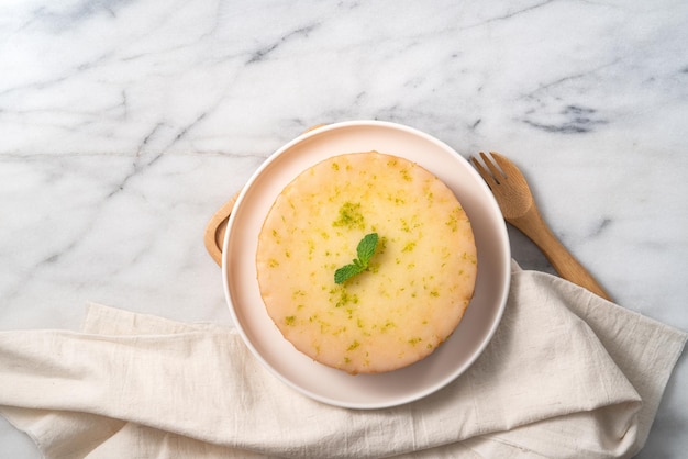 Deliziosa torta di spugna di libbra glassata al limone su sfondo di tavolo in marmo bianco