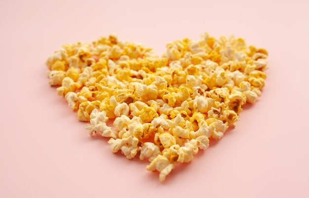 Deliziosi popcorn su sfondo rosa