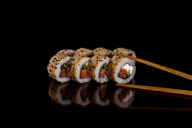 Deliziosi sushi rotoli freschi su uno sfondo scuro