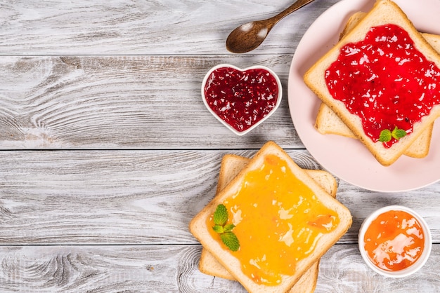 Deliziosi toast con varie marmellate dolci su grigio