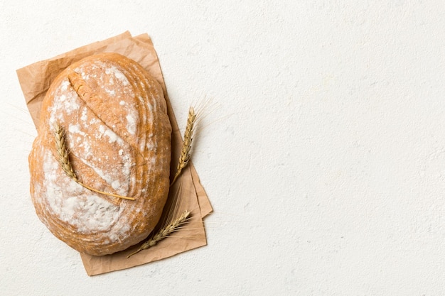 Delizioso pane francese appena sfornato con tovagliolo su tavolo rustico vista dall'alto Pane bianco sano