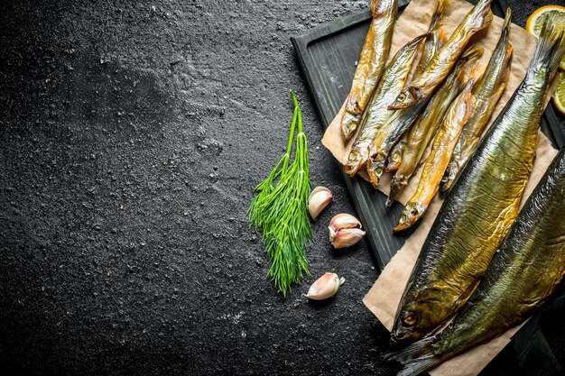 Delizioso pesce affumicato con aneto e spicchi d'aglio