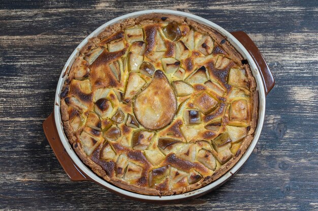 Dessert di torta di pere biologico fatto in casa pronto da mangiare Crostata di pere sul vecchio fondo di legno primo piano