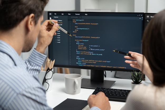 Developers program coding discussing website planning software Postulate