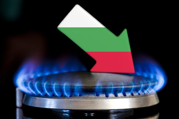 Diminuzione delle forniture di gas in Bulgaria Una stufa a gas con una fiamma accesa e una freccia con i colori della bandiera della Bulgaria rivolta verso il basso Concetto di crisi in inverno e mancanza di gas naturale