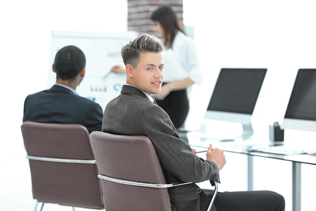 Dipendente dell'azienda sullo sfondo del team aziendale in un ufficio moderno