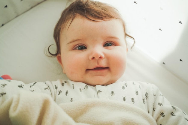 Direttamente sopra la foto di una bambina carina sdraiata sul letto a casa