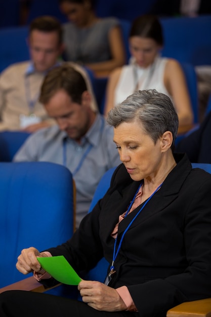 Dirigente aziendale guardando la carta verde al centro congressi