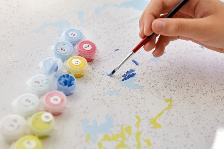 Disegno a mano di bambino con pennello su tela numerata