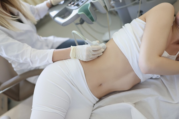 Dispositivo scanner a ultrasuoni in mano al medico professionista che esamina il suo paziente