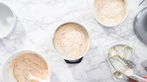 Disposizione piatta. Passo dopo passo. Misurare la pastella della torta funfetti su una bilancia da cucina digitale.