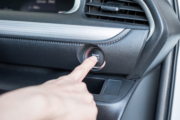 Dito che preme avvia l&#39;automobile del motore sul pannello di controllo