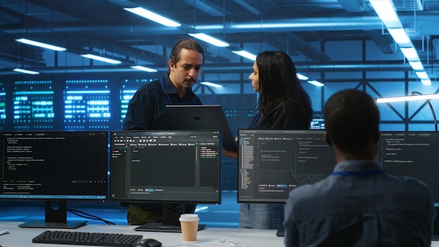 Diverse colleagues doing brainstorming discussing ways to fix servers