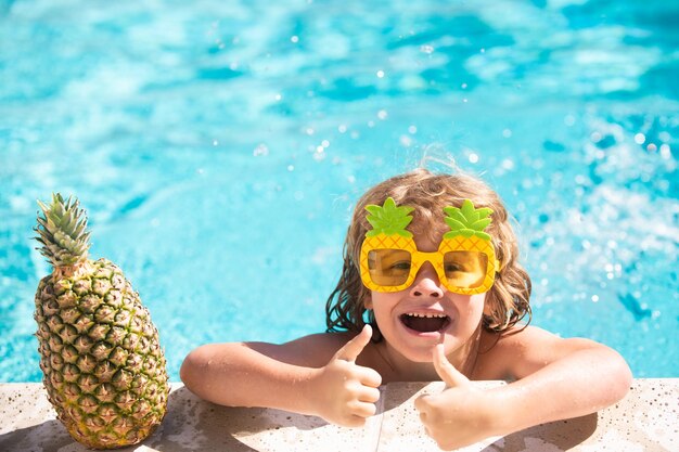 Divertimento per le vacanze estive Bambino carino in piscina Frutta di ananas estiva Divertente faccia stupita