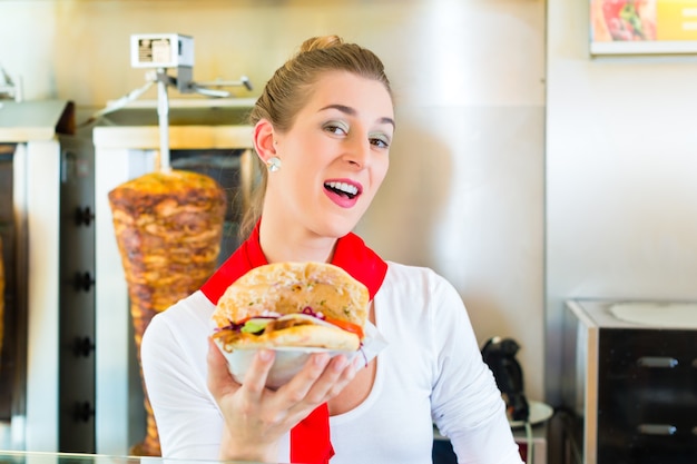 Doner kebab - venditore amichevole in un fast food turco, con pane pita o kebab appena fatto davanti allo spiedo