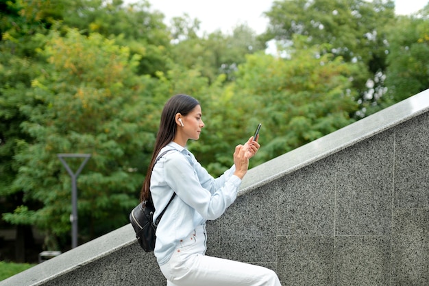 Donna a tiro medio con smartphone